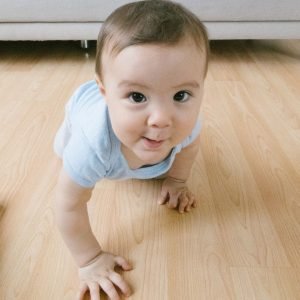 10 Tips to Help Your Baby Walk Photo by Meruyert Gonullu: https://www.pexels.com/photo/baby-in-blue-shirt-crawling-on-brown-wooden-floor-7499567/